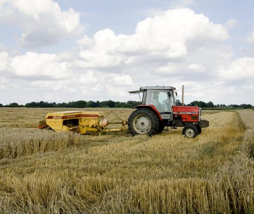 tractor harvesting wheat in a field